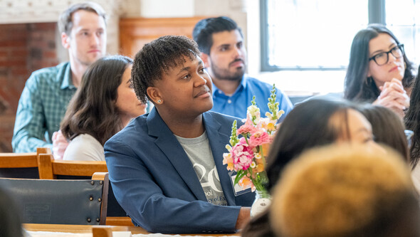 students in the YLS dining hall listening to a presentation
