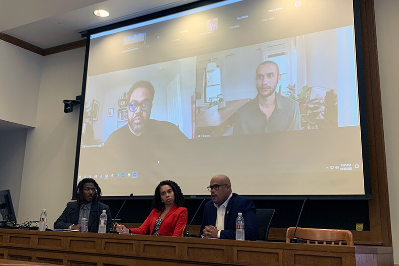 panelists seated and on zoom