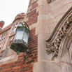 detail of a lantern at YLS against a brick and stone wall