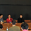 Four panelists seated at the front of a classroom