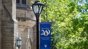 blue banner on a lamppost for the Law School bicentennial
