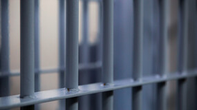A close-up of bars on a prison cell